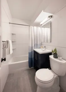 a bathroom with a sink toilet and shower