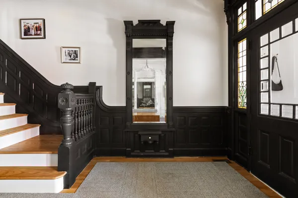 a view of entryway and hall with wooden floor