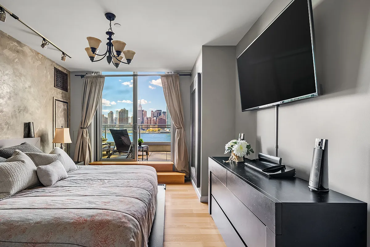 46-30 Center Boulevard, Unit 710 Queens, NY 11109 - Photo 3 of 25 a bedroom with a bed window and flat screen tv