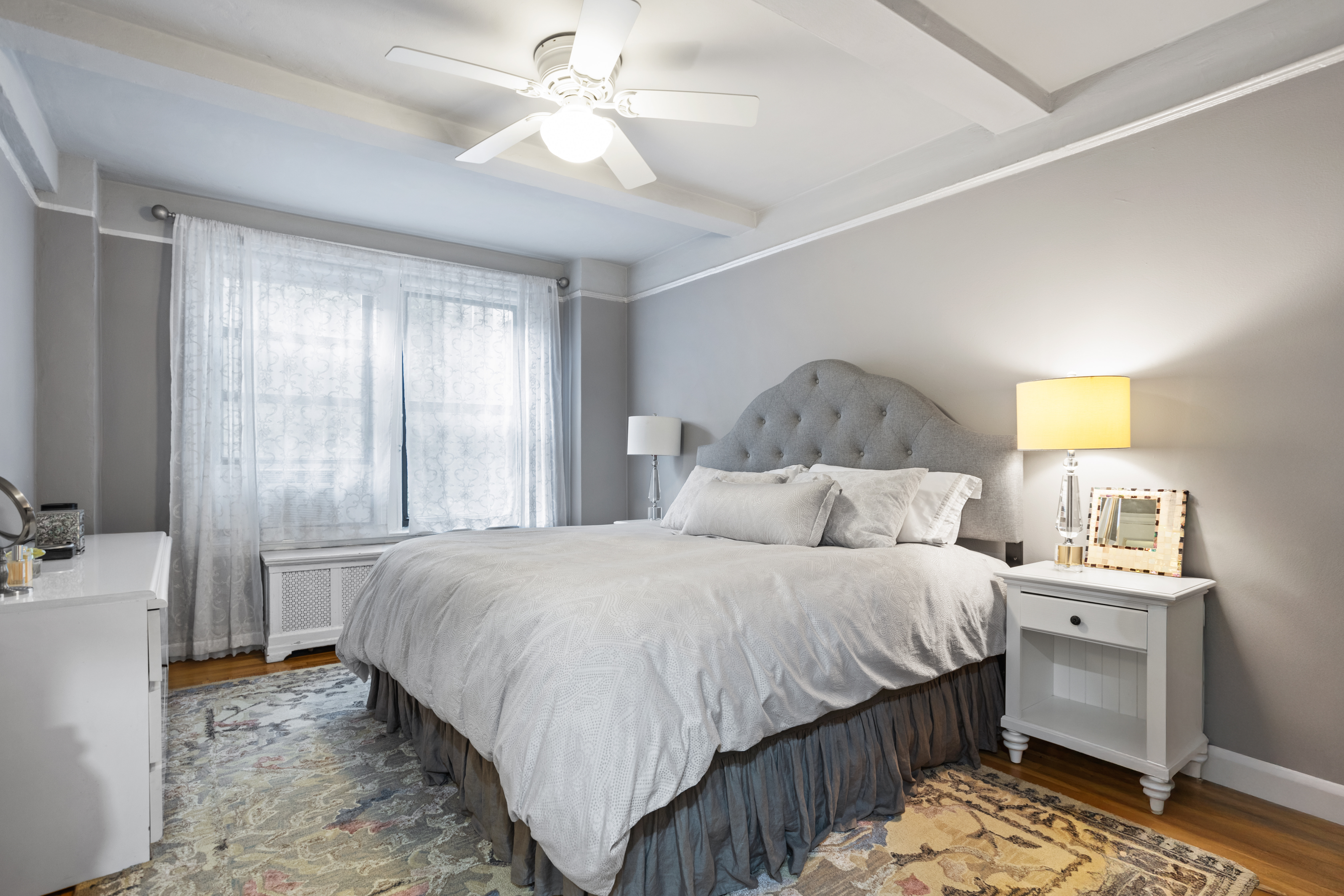 107 West 86th Street, Unit 3H Manhattan, NY 10024 - Photo 5 of 7 a bedroom with a bed and a chandelier