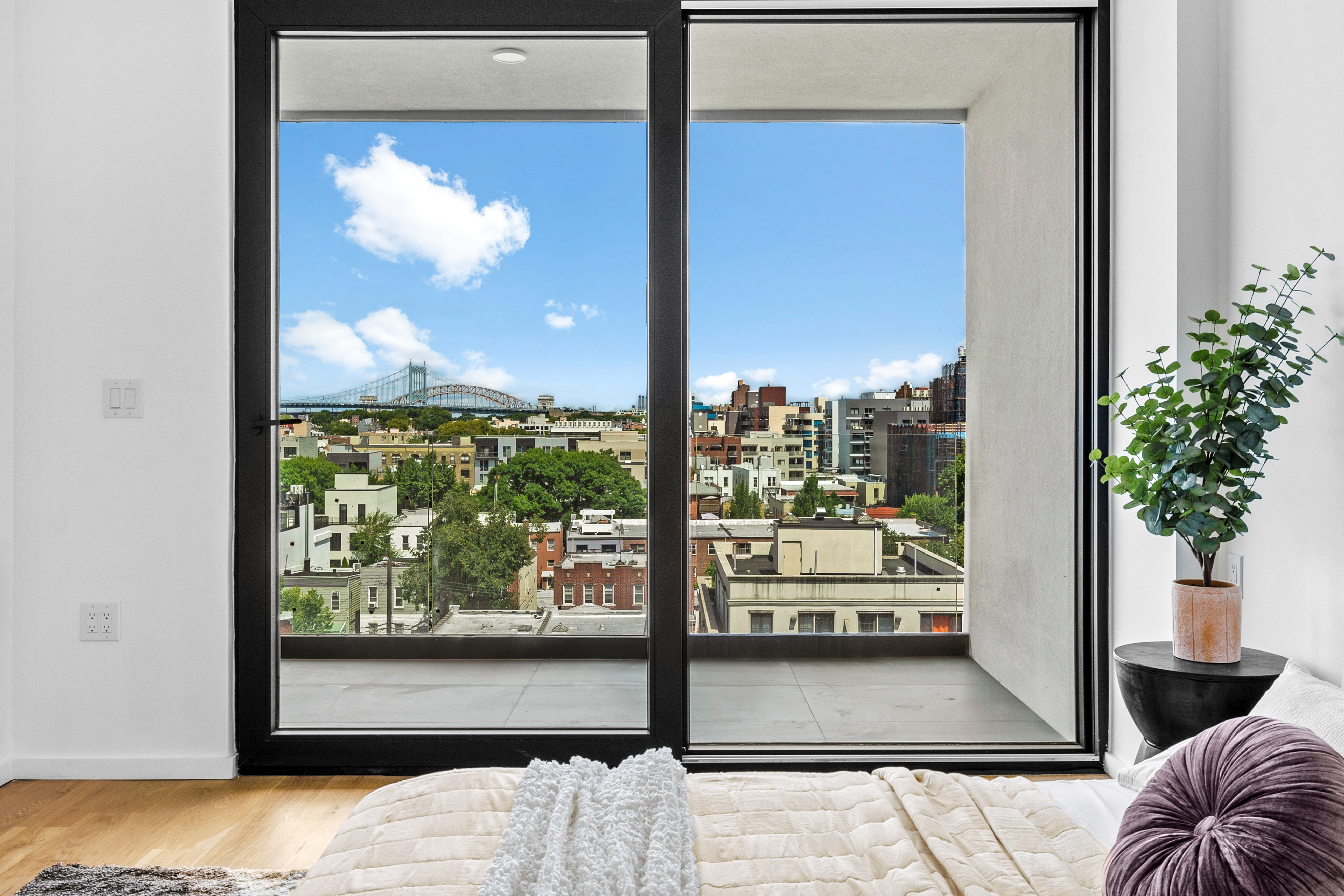 14-35 Broadway, Unit PH Queens, NY 11106 - Photo 12 of 24 a view of a glass door with a balcony from a window