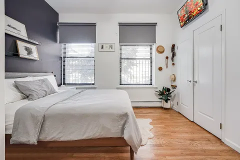 a spacious bedroom with a bed and a window