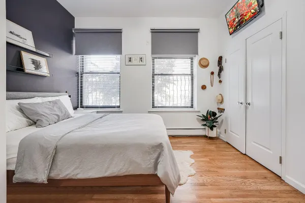 a spacious bedroom with a bed and a window