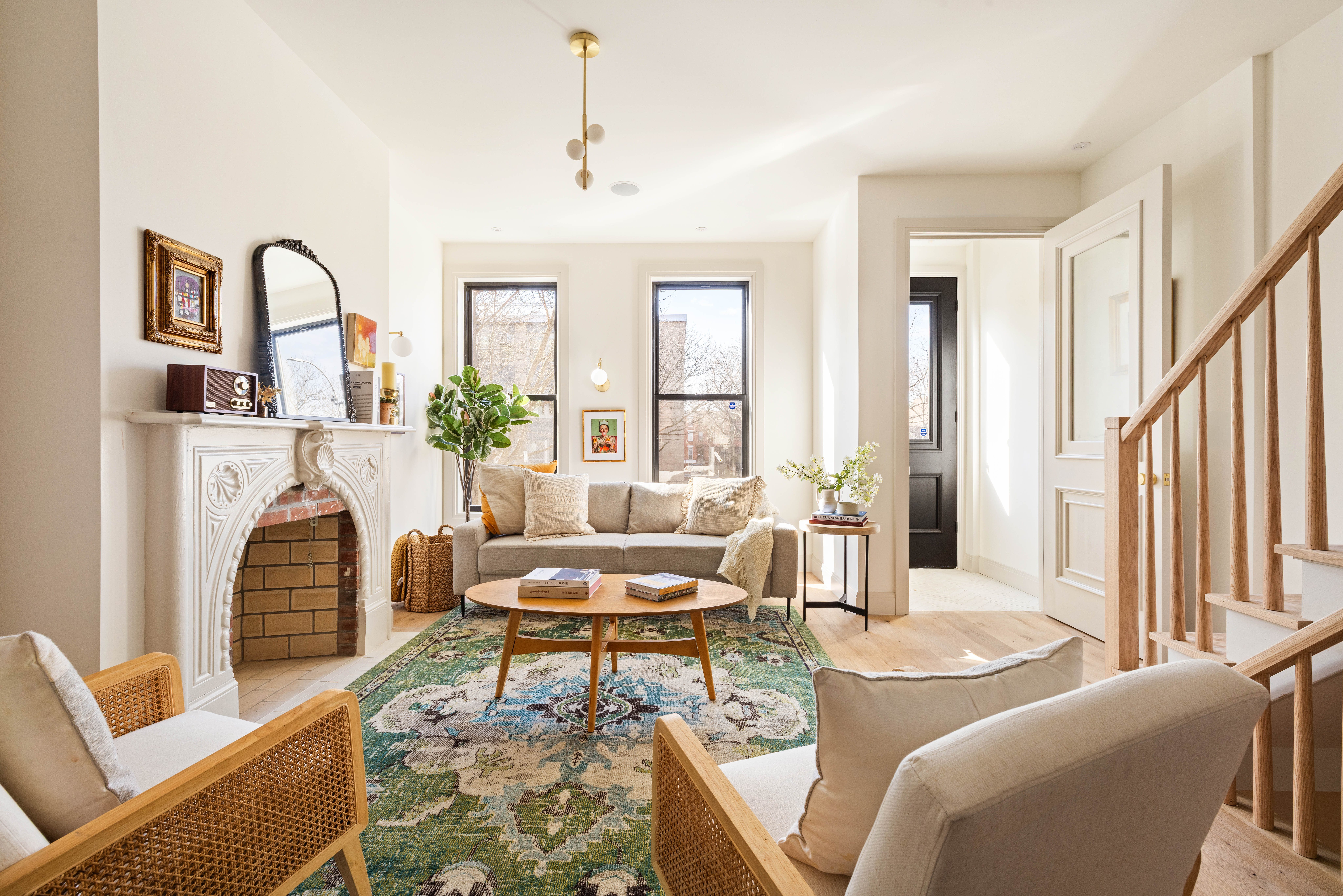 a living room with furniture a fireplace and a large window