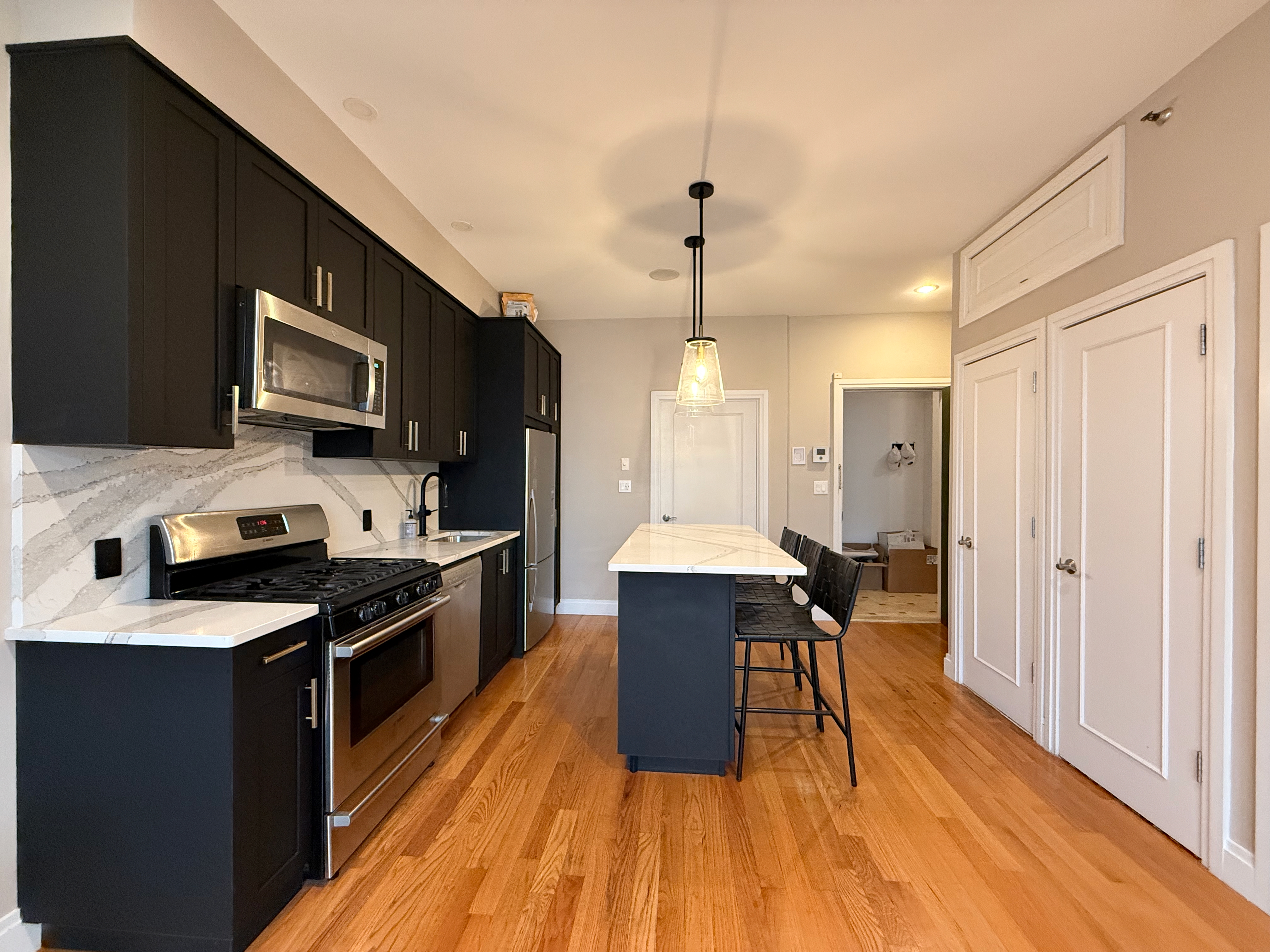 151 Green Street, Unit 2A Brooklyn, NY 11222 - Photo 3 of 6 a kitchen with stainless steel appliances wooden floors stove and cabinets