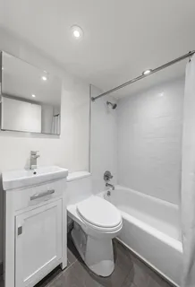 a view of a livingroom with furniture and floor to ceiling window