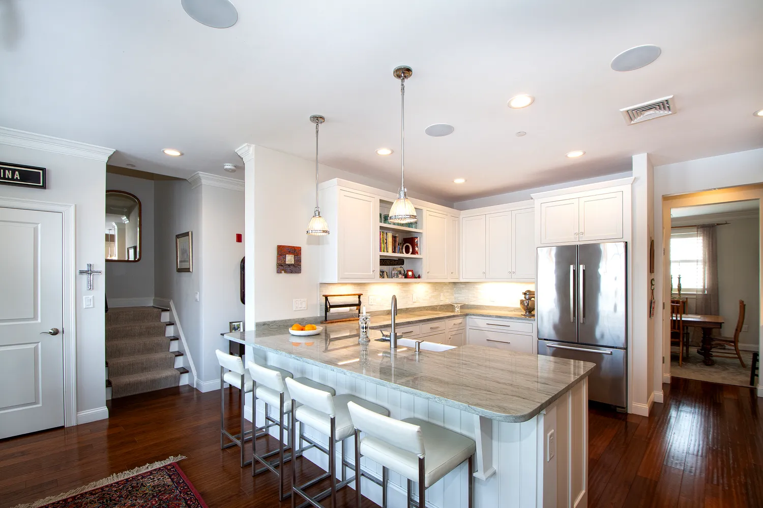 a kitchen with stainless steel appliances granite countertop a stove refrigerator and cabinets