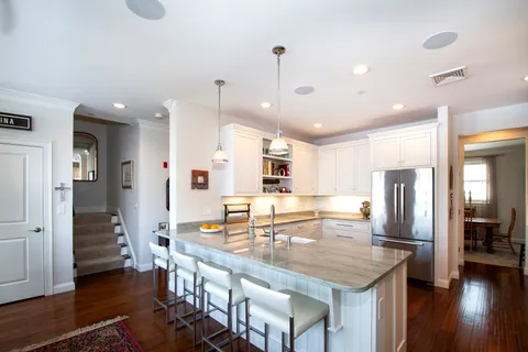 a kitchen with stainless steel appliances granite countertop a stove refrigerator and cabinets