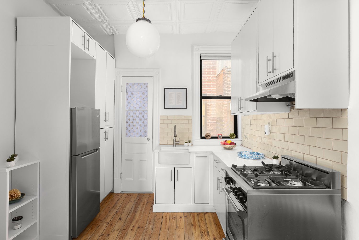 a kitchen with a stove and a refrigerator