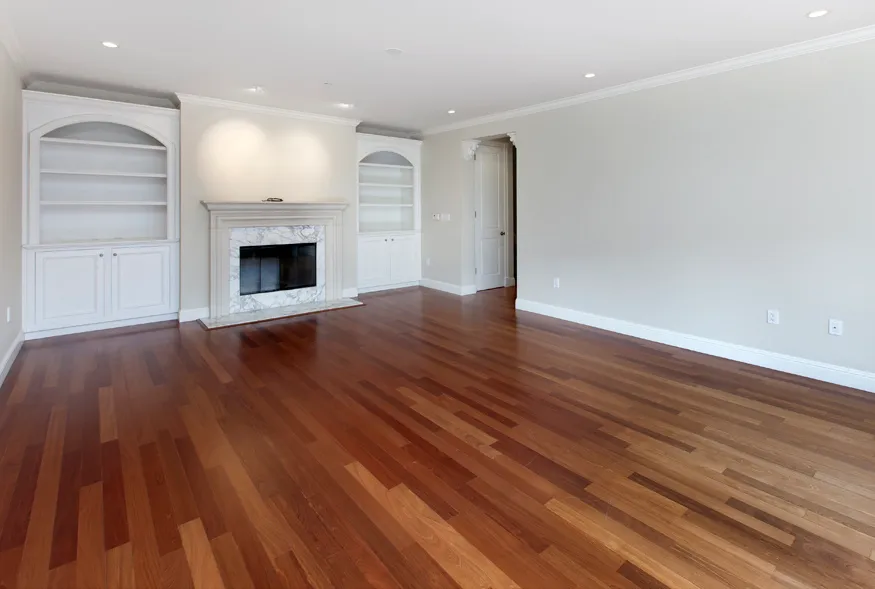 a view of empty room with wooden floor