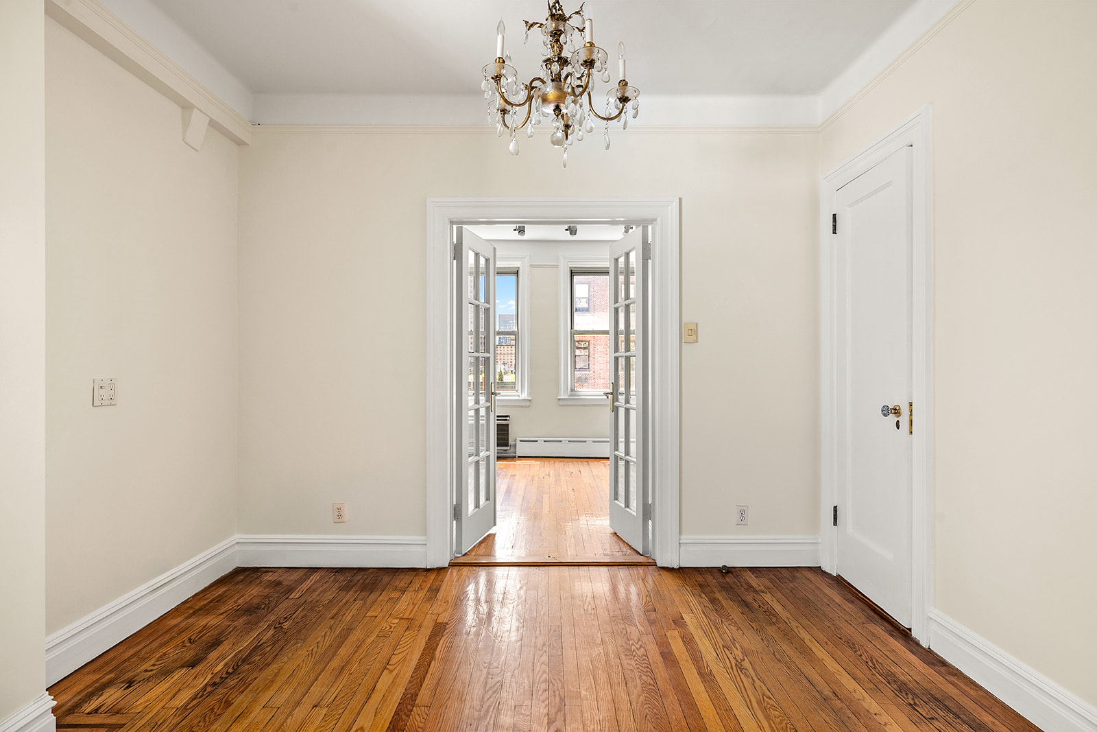 345 West 55th Street, Unit 8AB Manhattan, NY 10019 - Photo 8 of 14 a view of a room with wooden floor and chandelier