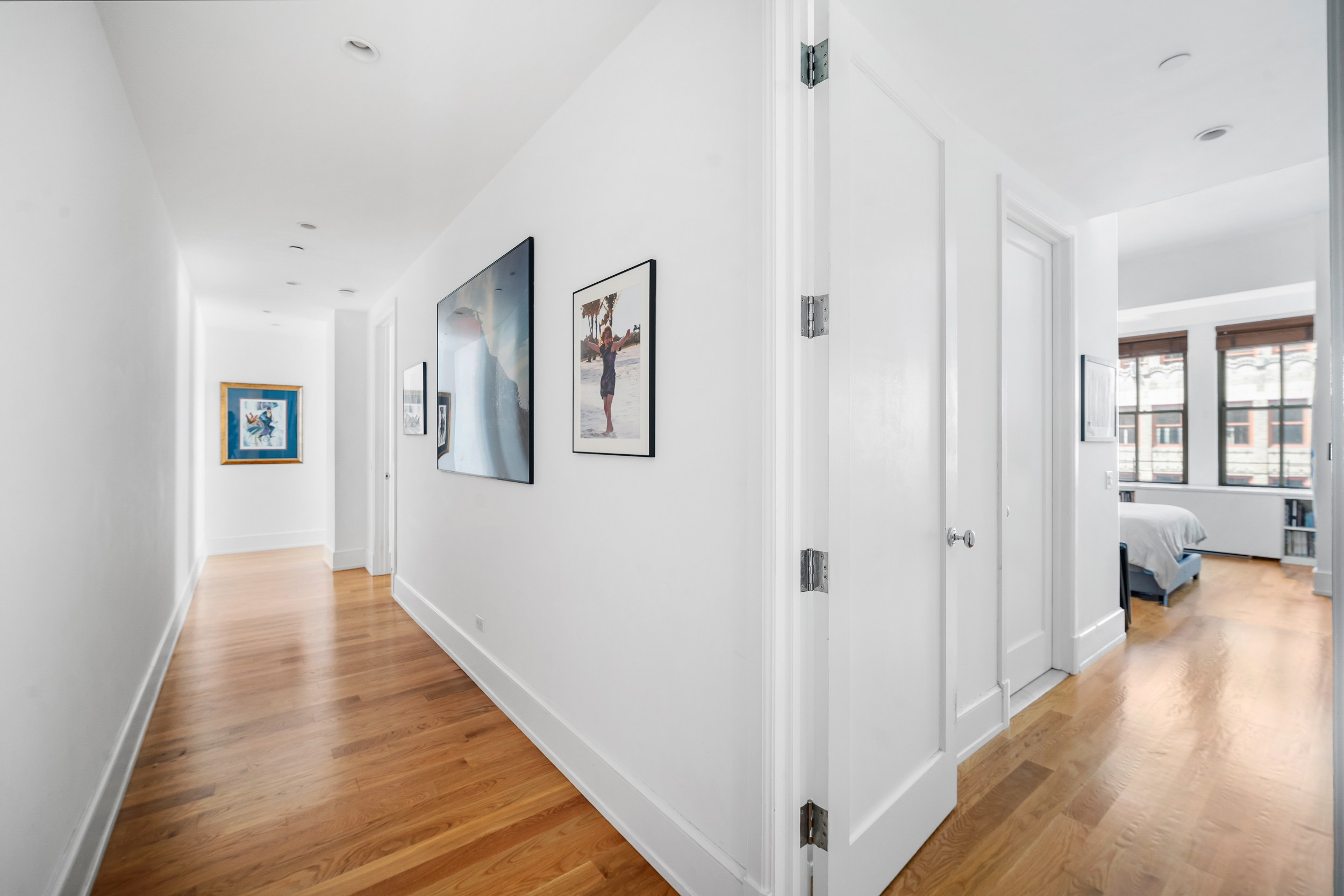 130 West 30th Street, Unit 16A Manhattan, NY 10001 - Photo 6 of 17 a view of a hallway with wooden floor and staircase