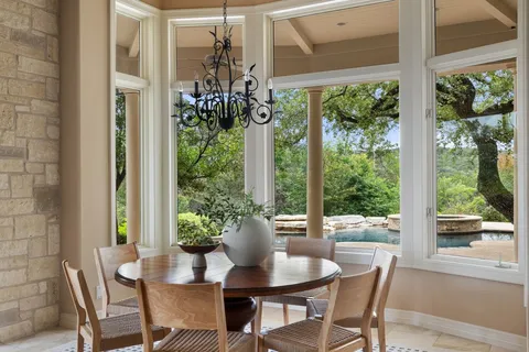 a view of a dining room with furniture window and outside view