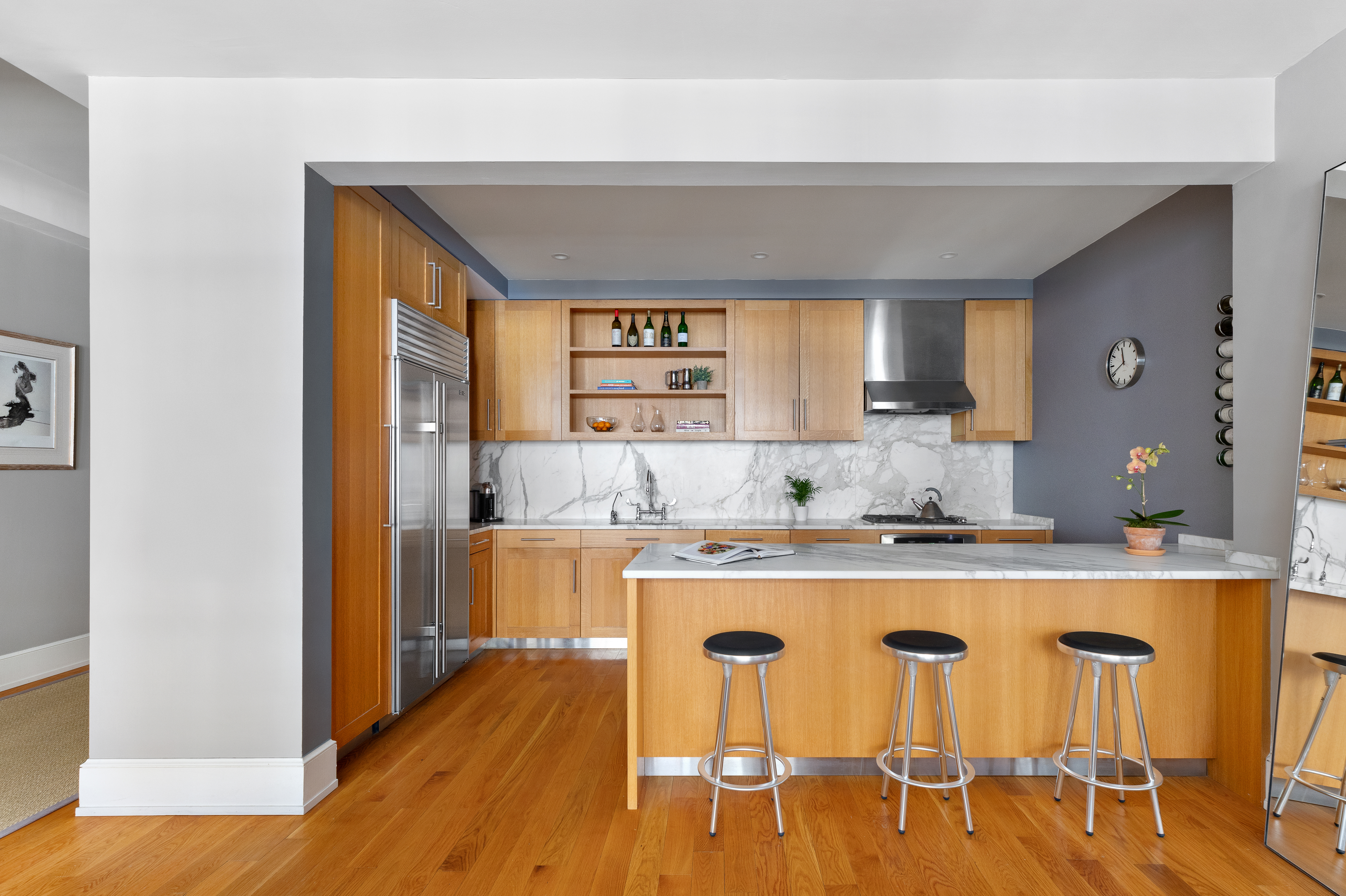 130 West 30th Street, Unit 3B Manhattan, NY 10001 - Photo 5 of 15 a kitchen with dining table chairs and wooden floor