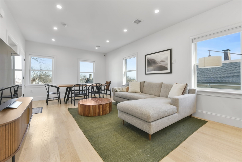 17 Akron Street, Unit 2 Boston, MA 02119 - Photo 2 of 26 a living room with furniture and wooden floor