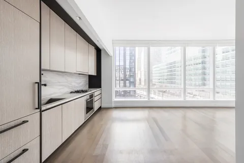a large kitchen with granite countertop a lot of counter space and wooden floor