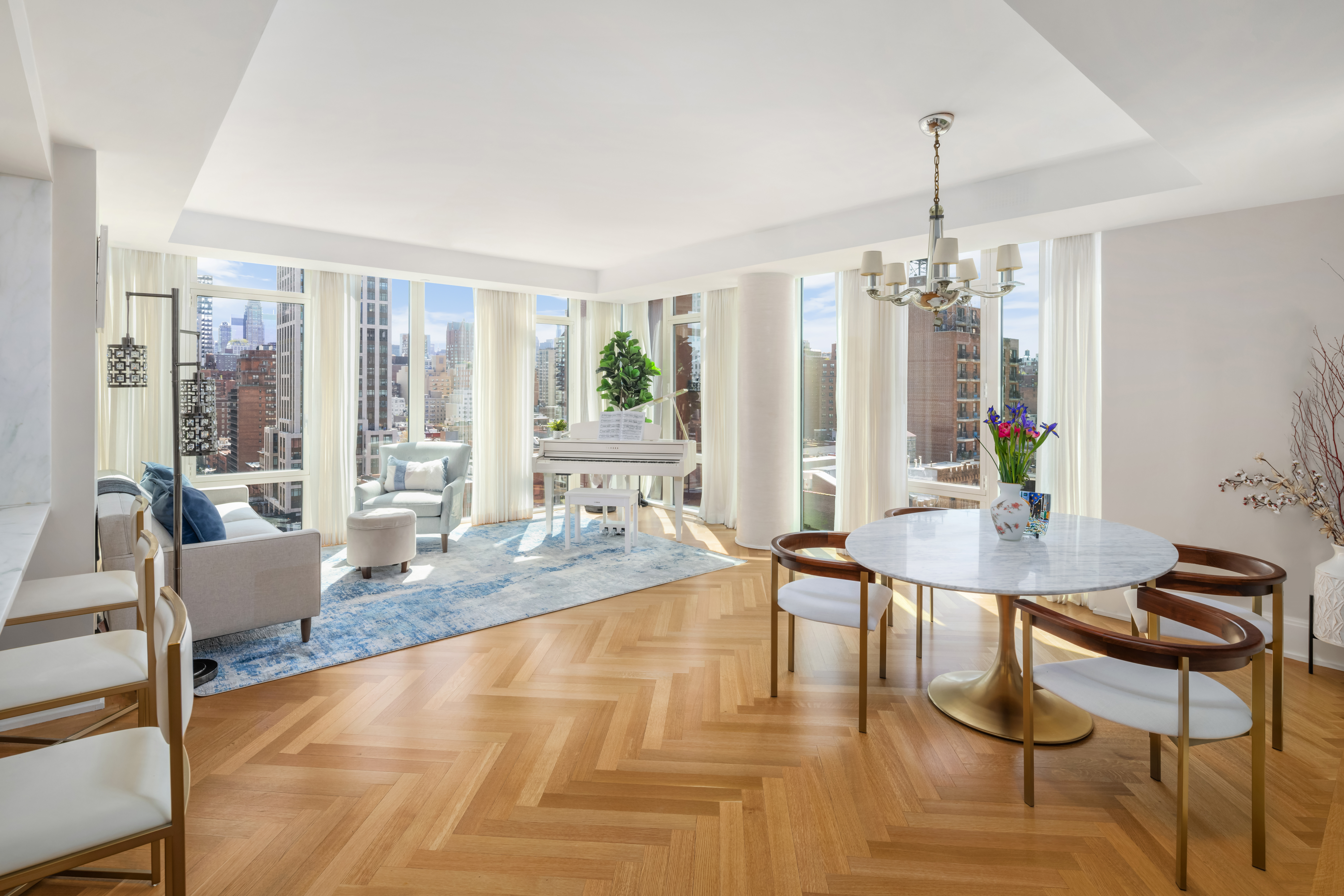 a dining room with furniture a chandelier and wooden floor