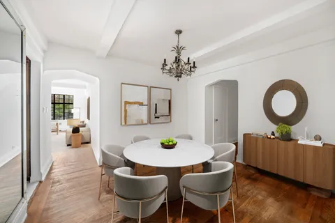 a living room with furniture and a mirror