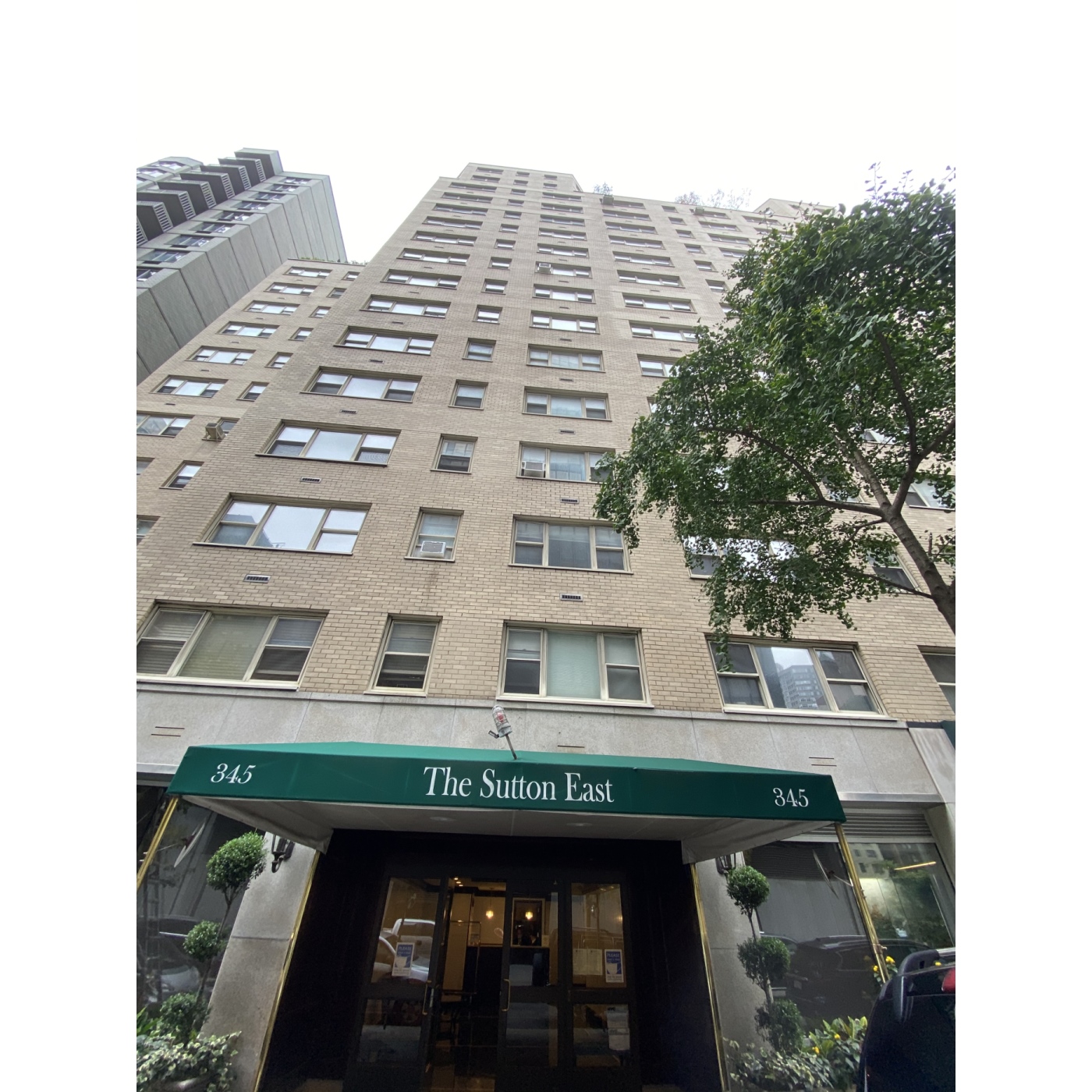 345 East 56th Street, Unit 11C Manhattan, NY 10022 - Photo 13 of 15 a front view of a building with glass windows