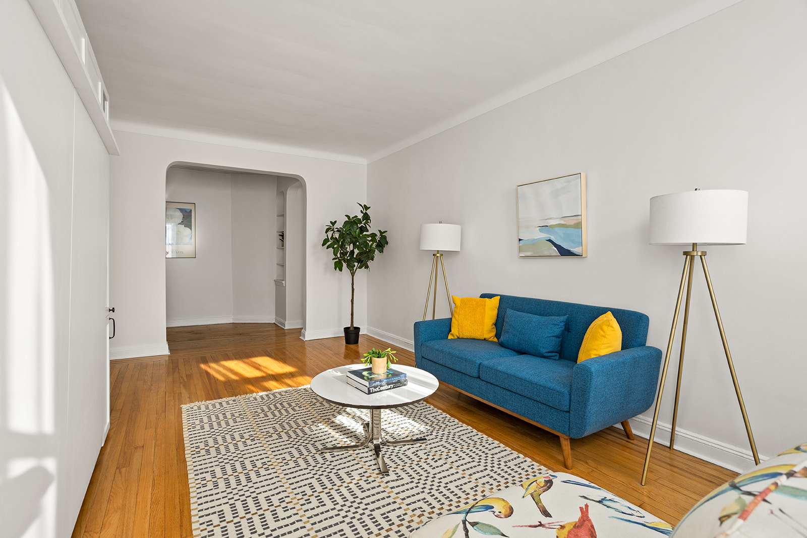 76-12 35th Avenue, Unit J6 Queens, NY 11372 - Photo 2 of 14 a living room with furniture and a rug
