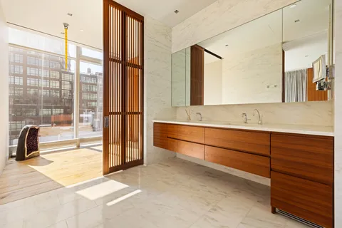 a bathroom with a double vanity sink and a mirror