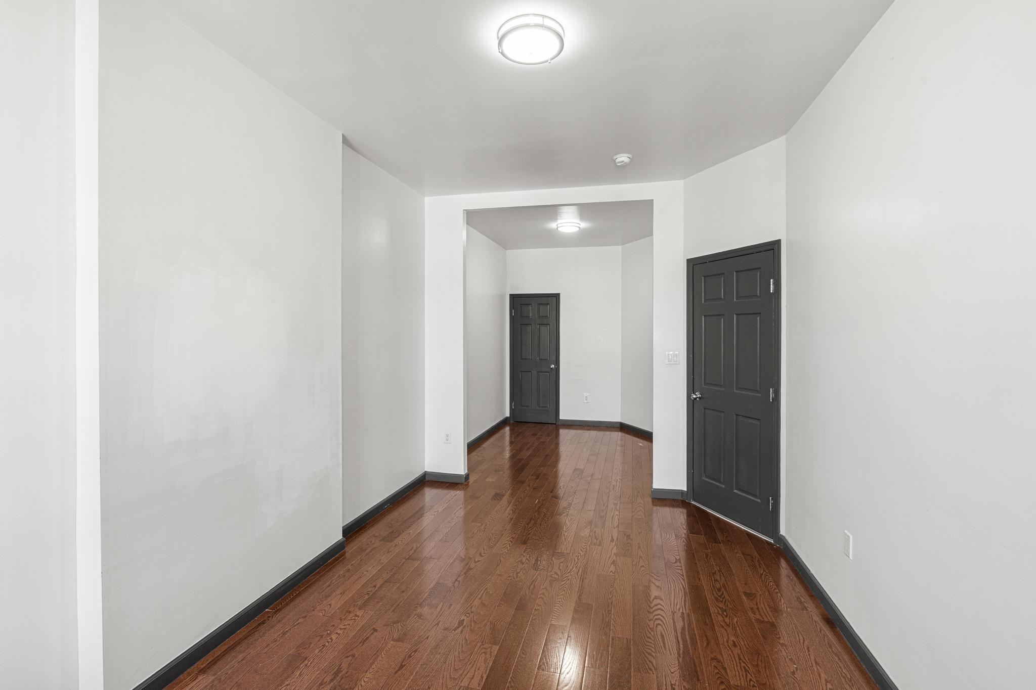 1389 Fulton Street, Unit 3 Brooklyn, NY 11216 - Photo 4 of 12 a view of a hallway with wooden floor