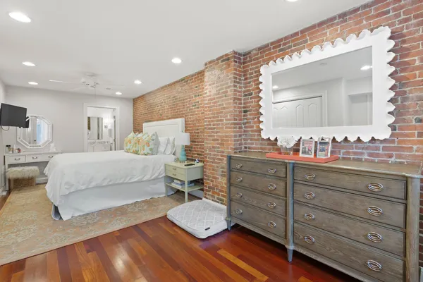 a bedroom with a bed and a dresser