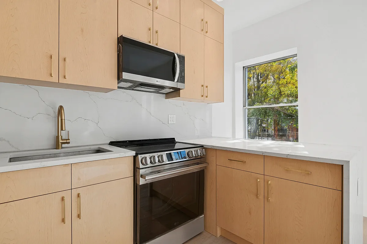 457 Bergen Street, Unit 2F Brooklyn, NY 11217 - Photo 7 of 12 a kitchen with a stove and a microwave