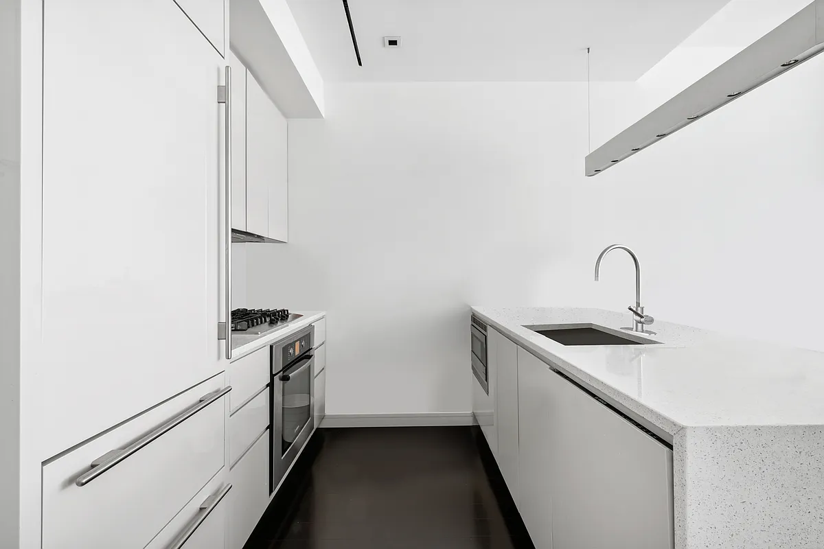 300 East 23rd Street, Unit 5B Manhattan, NY 10010 - Photo 3 of 10 a utility room with sink dryer and washer