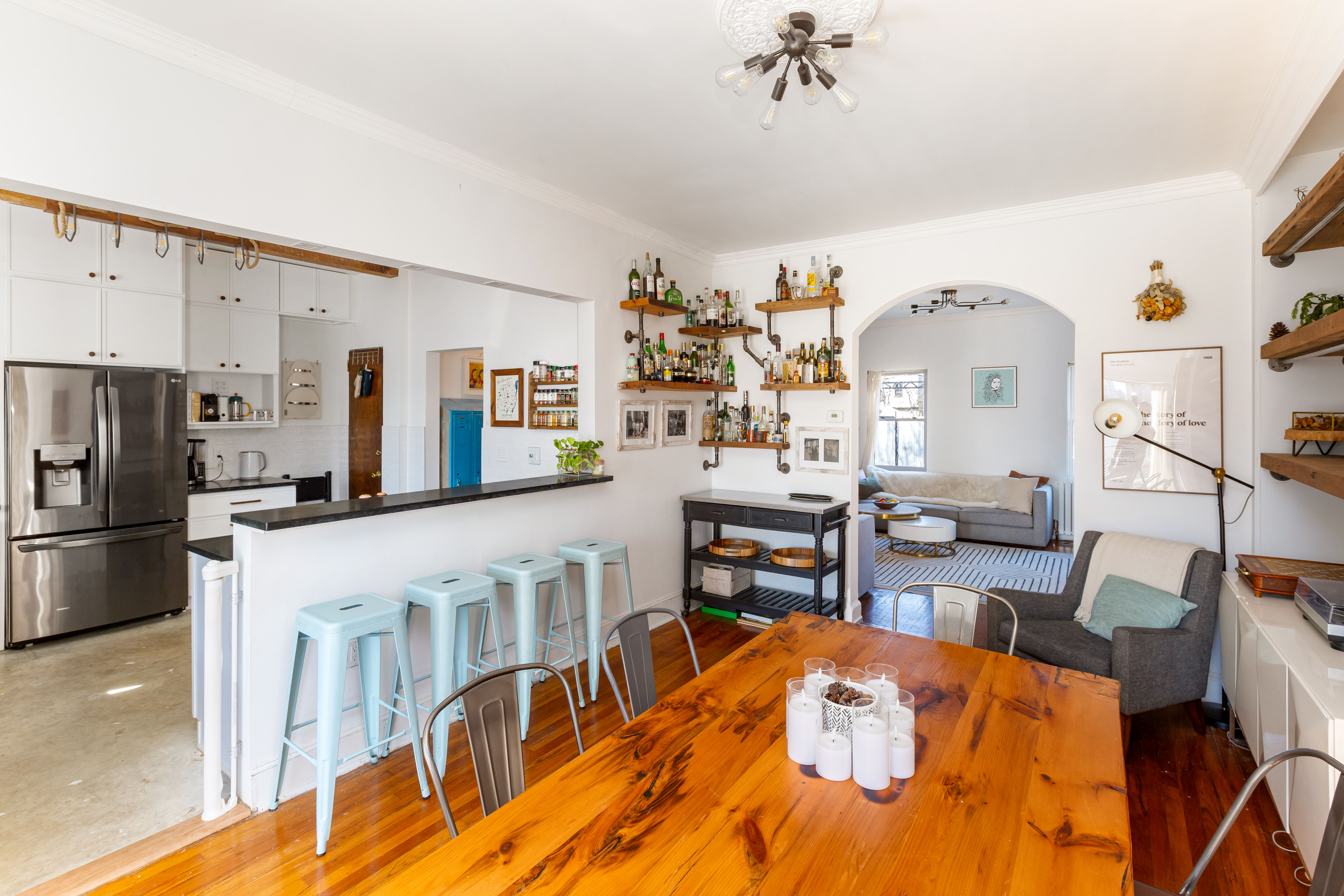 214 Eagle Street Brooklyn, NY 11222 - Photo 3 of 13 a kitchen with stainless steel appliances kitchen island granite countertop a refrigerator a stove a dining table and chairs with wooden floor