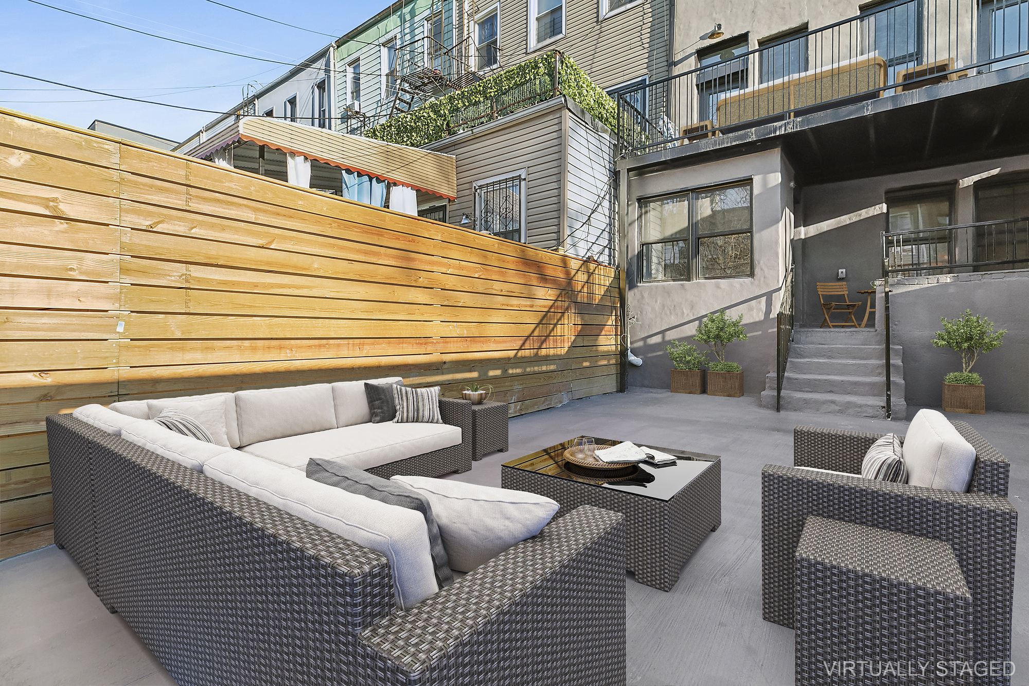 1265 Madison Street, Unit 1 Brooklyn, NY 11221 - Photo 5 of 11 a view of a patio with couches chairs and potted plants