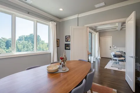 a view of a dining room with furniture window and wooden floor