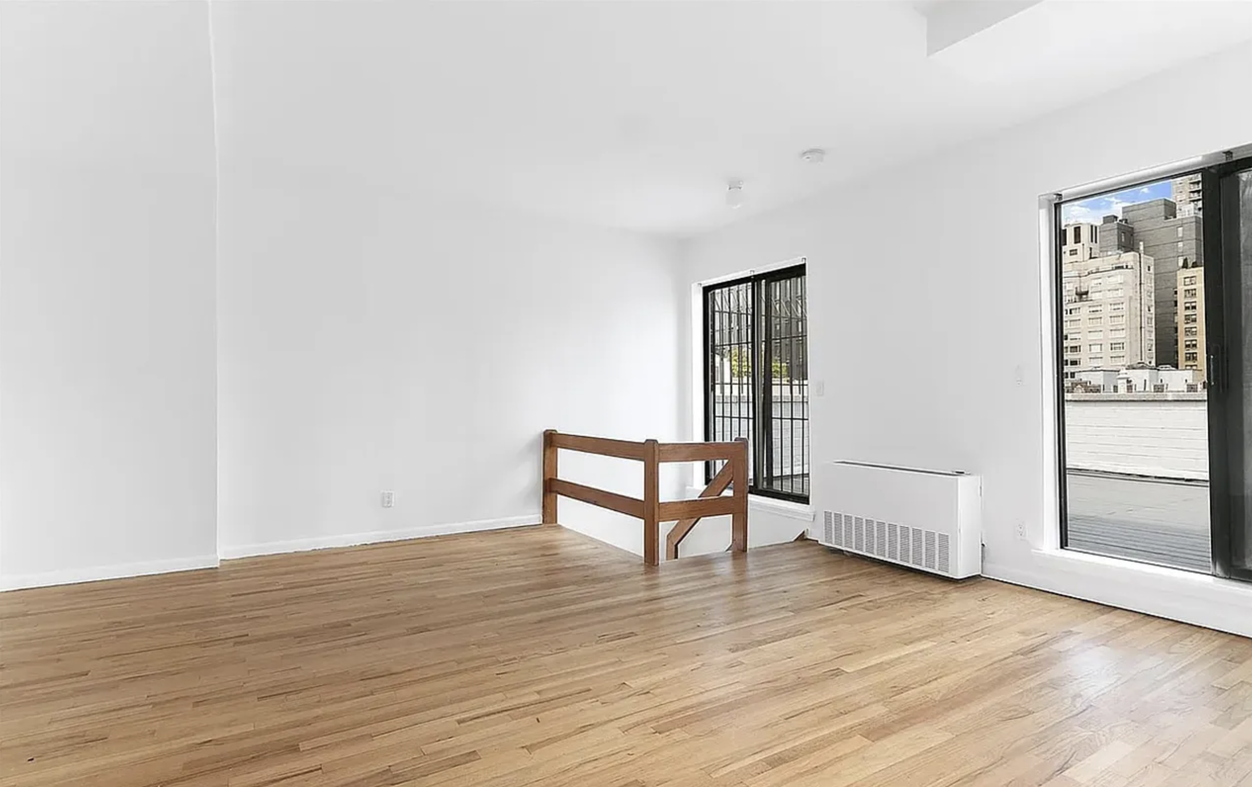 343 East 76th Street, Unit 6B Manhattan, NY 10021 - Photo 4 of 8 a view of a room with wooden floor and next to a window