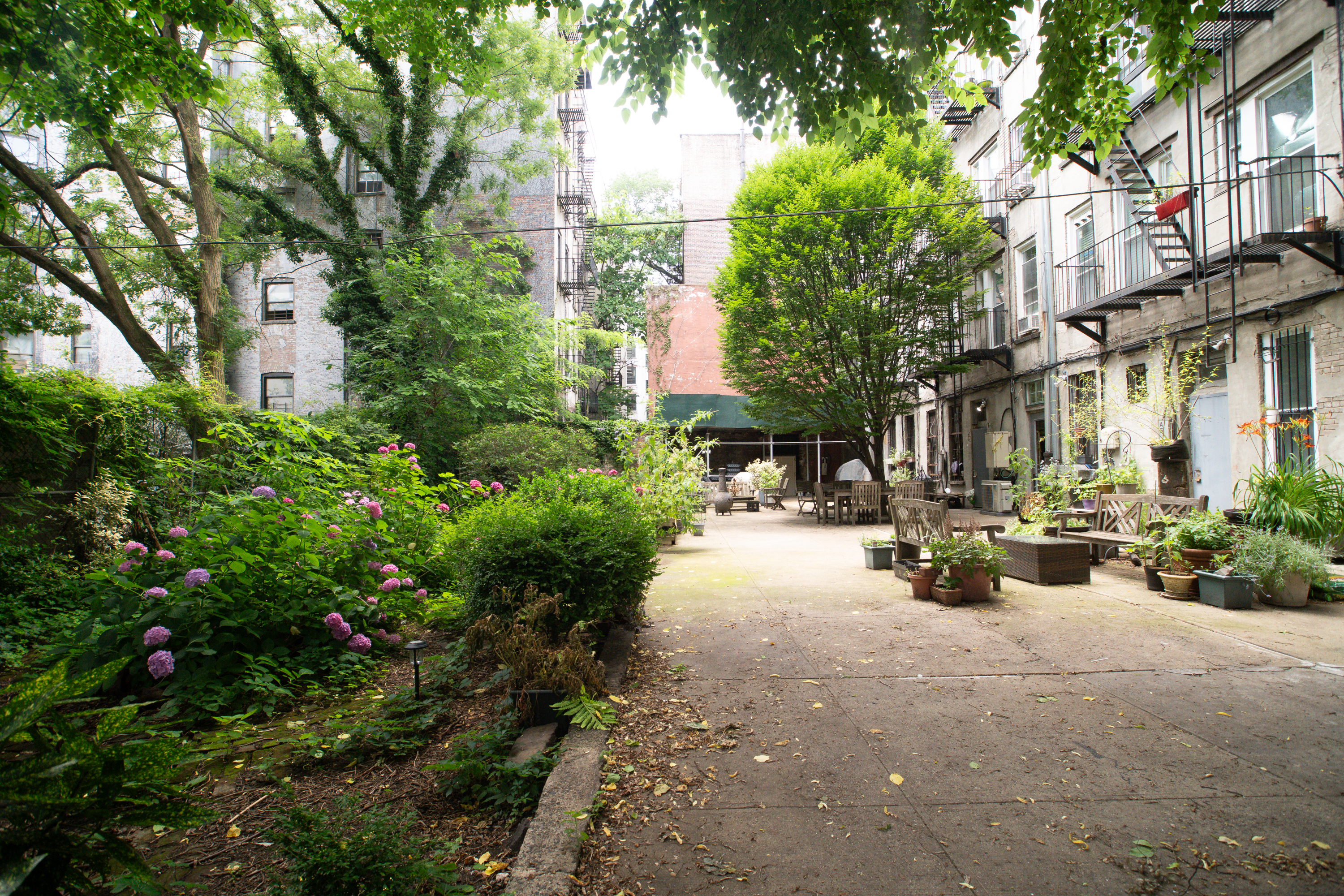 616 East 9th Street, Unit 4W Manhattan, NY 10009 - Photo 18 of 20 a view of a patio with table and chairs under an umbrella