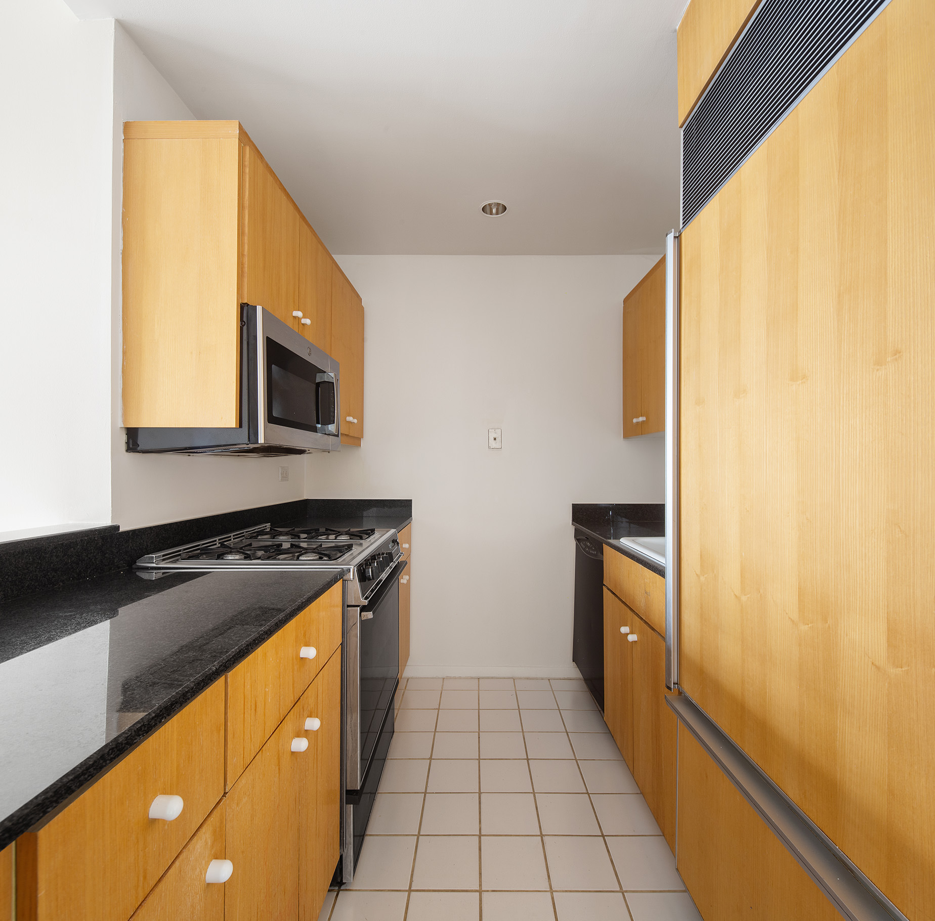 160 West 66th Street, Unit 33A Manhattan, NY 10023 - Photo 10 of 11 a kitchen with stainless steel appliances granite countertop a stove a sink and a microwave