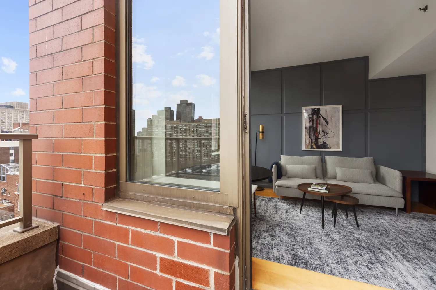 a living room with furniture and a floor to ceiling window
