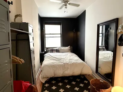 a bedroom with a bed and a window