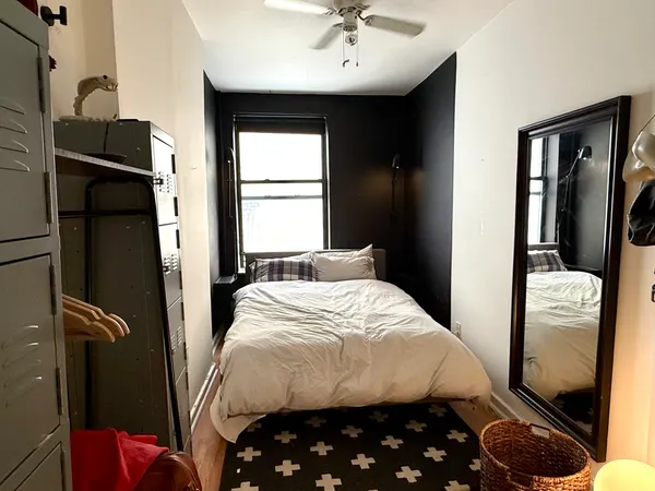 a bedroom with a bed and a window