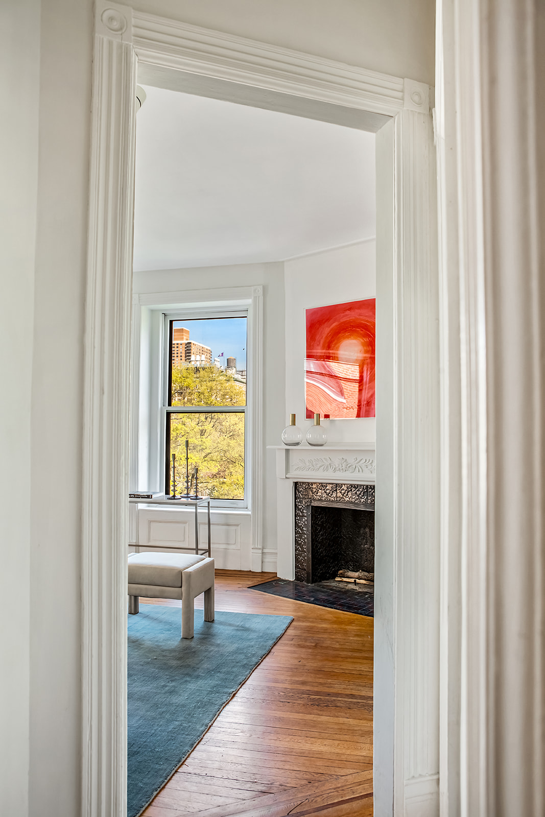 39 1/2 Washington Square South, Unit 9 Manhattan, NY 10012 - Photo 6 of 12 a view of an empty room with window and fireplace