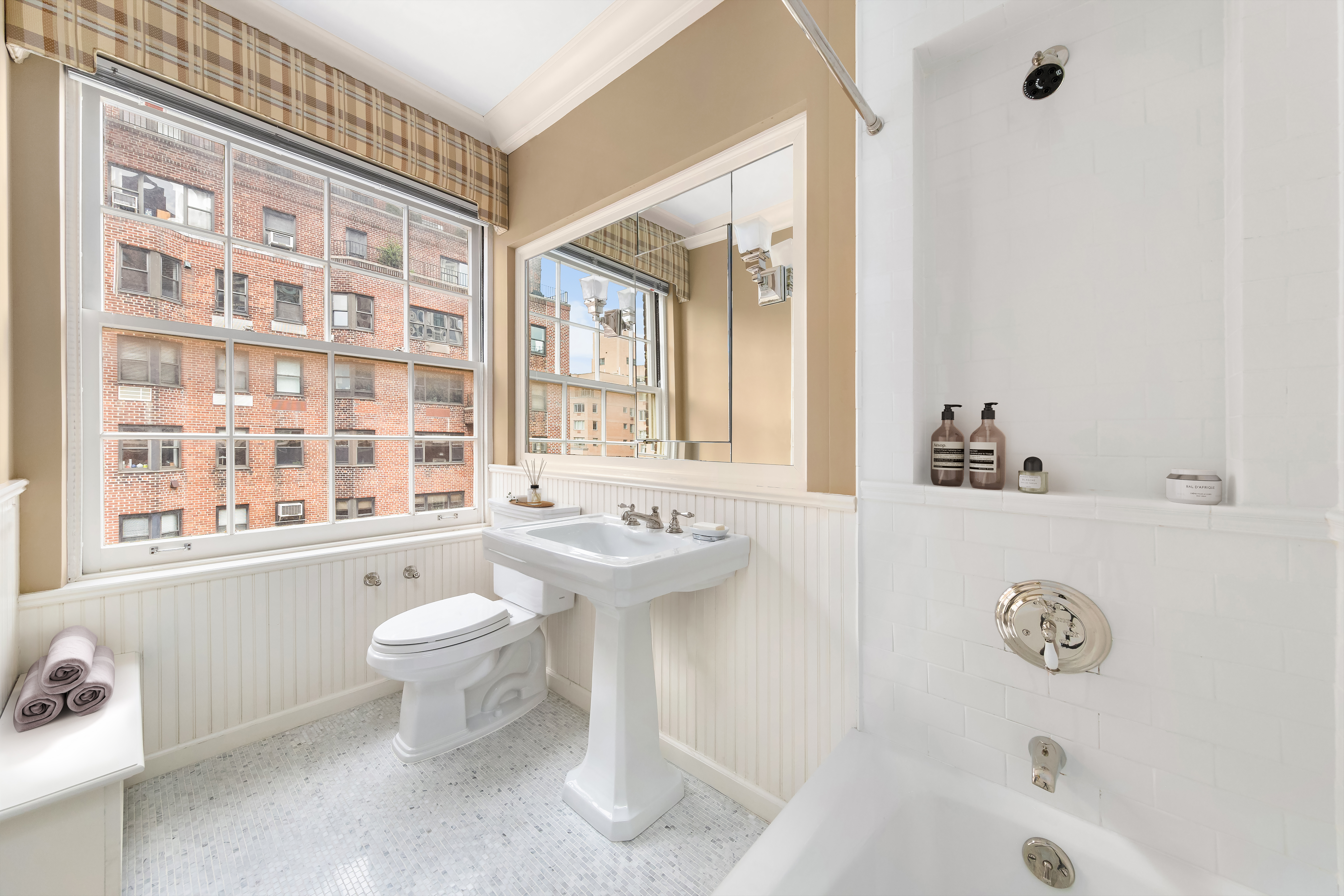 14 Sutton Place South, Unit PHA Manhattan, NY 10022 - Photo 15 of 22 a bathroom with a sink toilet a mirror and bathtub