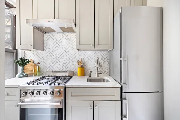 a kitchen with a stove and a refrigerator