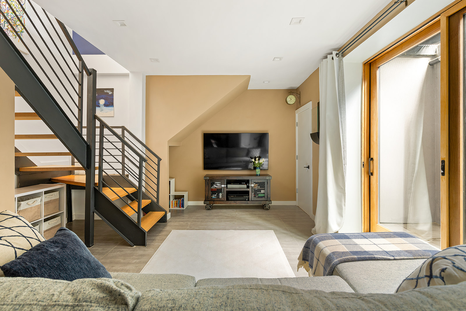 267 Evergreen Avenue, Unit 1 Brooklyn, NY 11221 - Photo 6 of 11 a living room with furniture and a flat screen tv