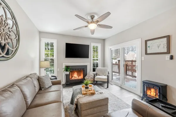 a living room with furniture a fireplace and a flat screen tv