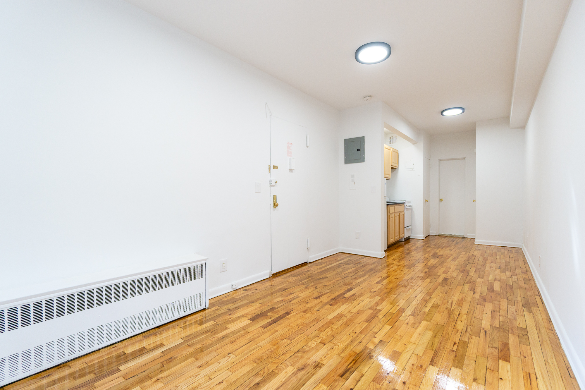 227 East 5th Street, Unit BE Manhattan, NY 10003 - Photo 2 of 7 a view of a bedroom with wooden floor