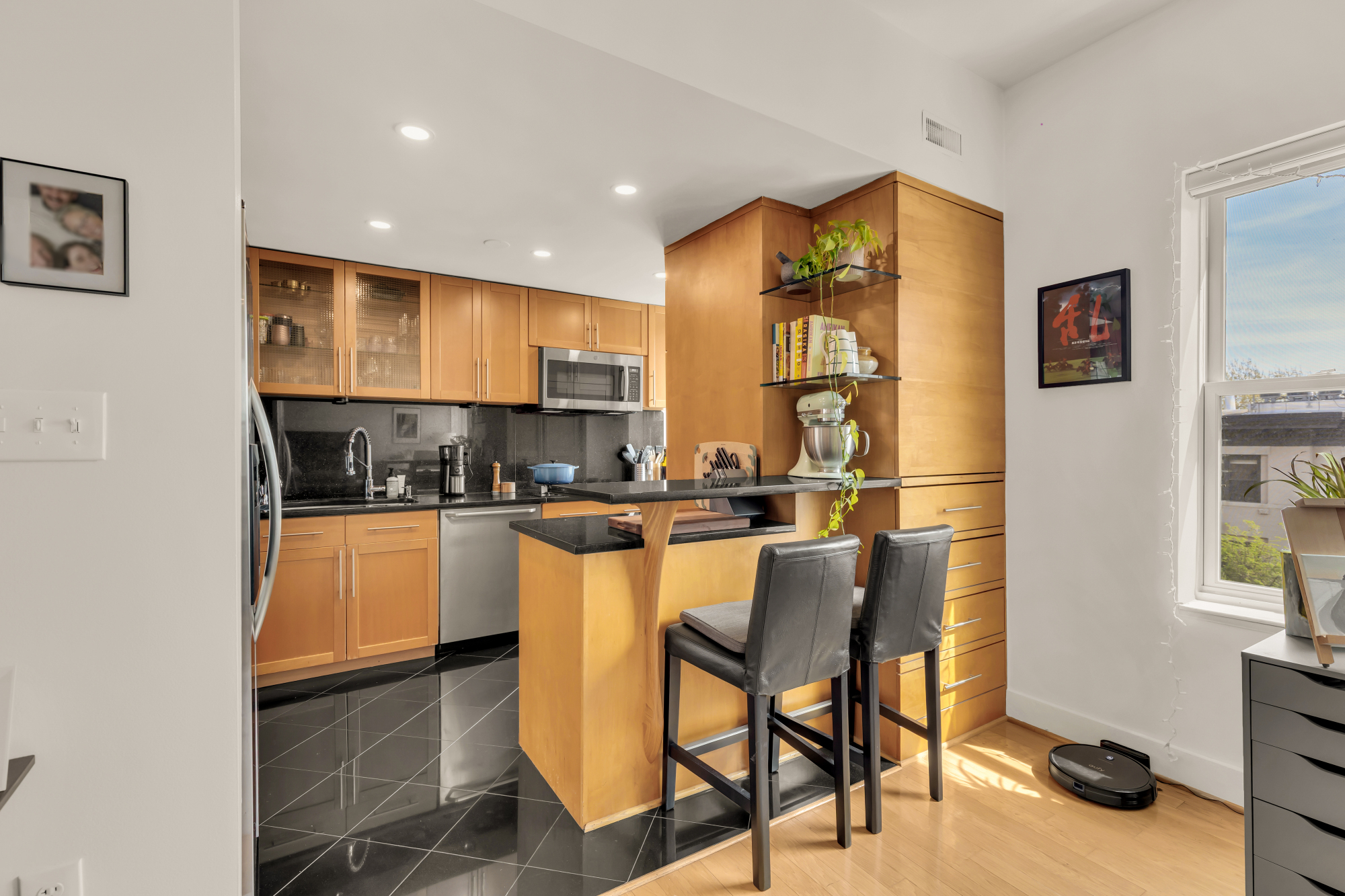 2127 California Street Northwest, Unit 505 Washington, DC 20008 - Photo 16 of 40 a kitchen with stainless steel appliances granite countertop a stove a sink and a refrigerator
