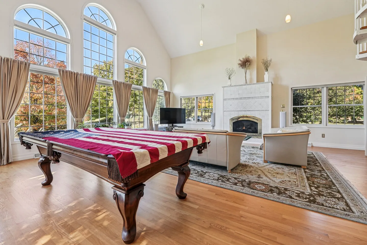 a living room with furniture a rug and a fireplace