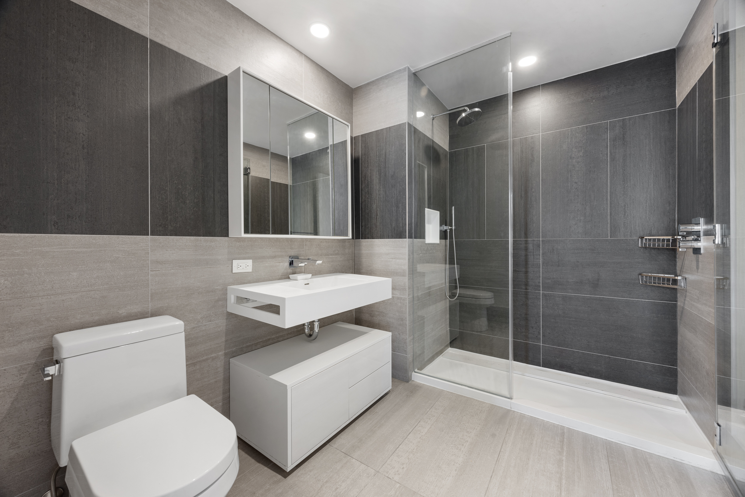 540 West 49th Street, Unit PH1N Manhattan, NY 10019 - Photo 13 of 18 a bathroom with a sink toilet and shower