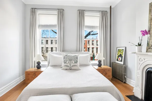 a bedroom with a bed and a window