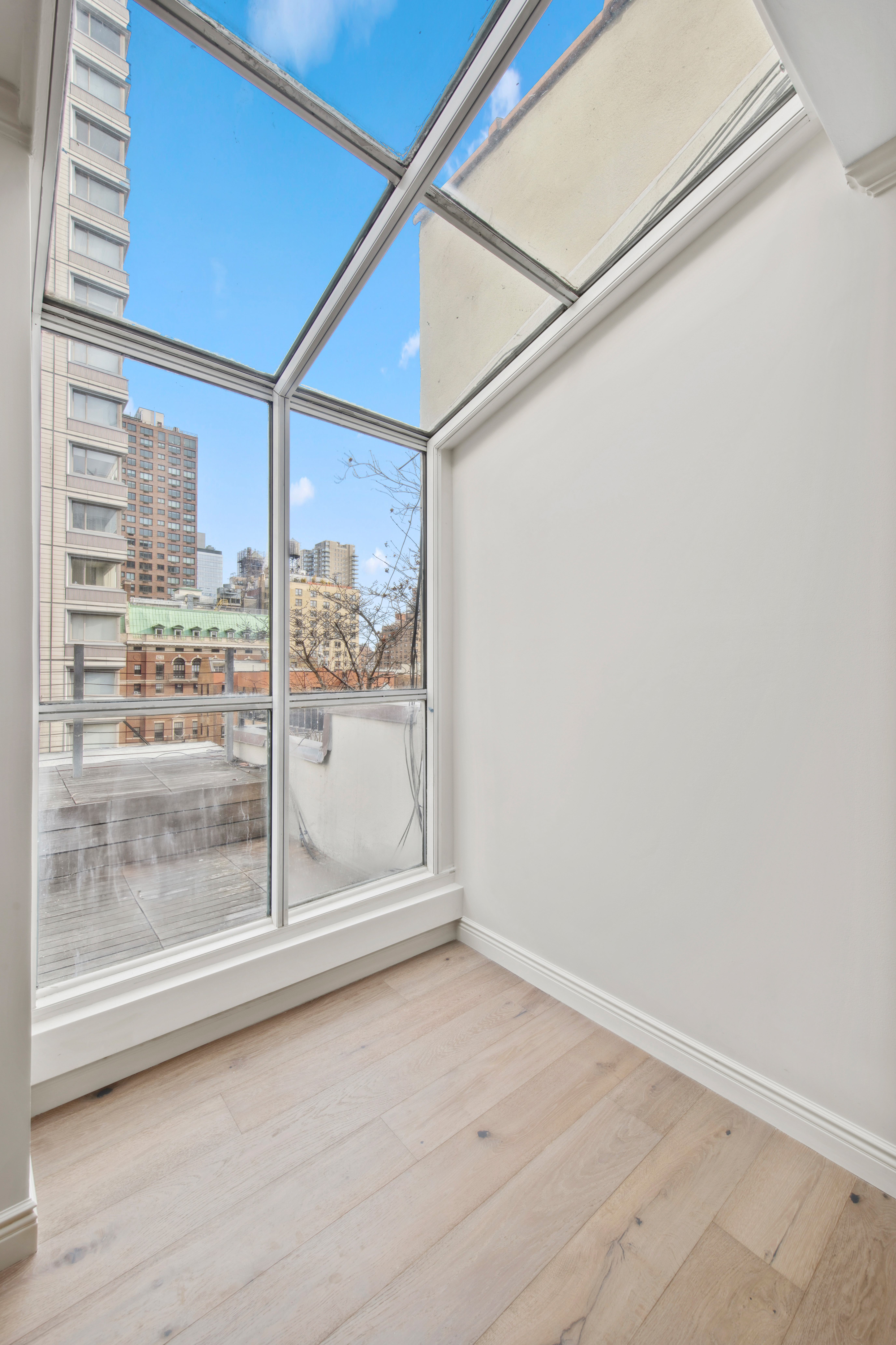 212 East 70th Street, Unit 4B Manhattan, NY 10021 - Photo 10 of 16 a view of a big room with wooden floor and door