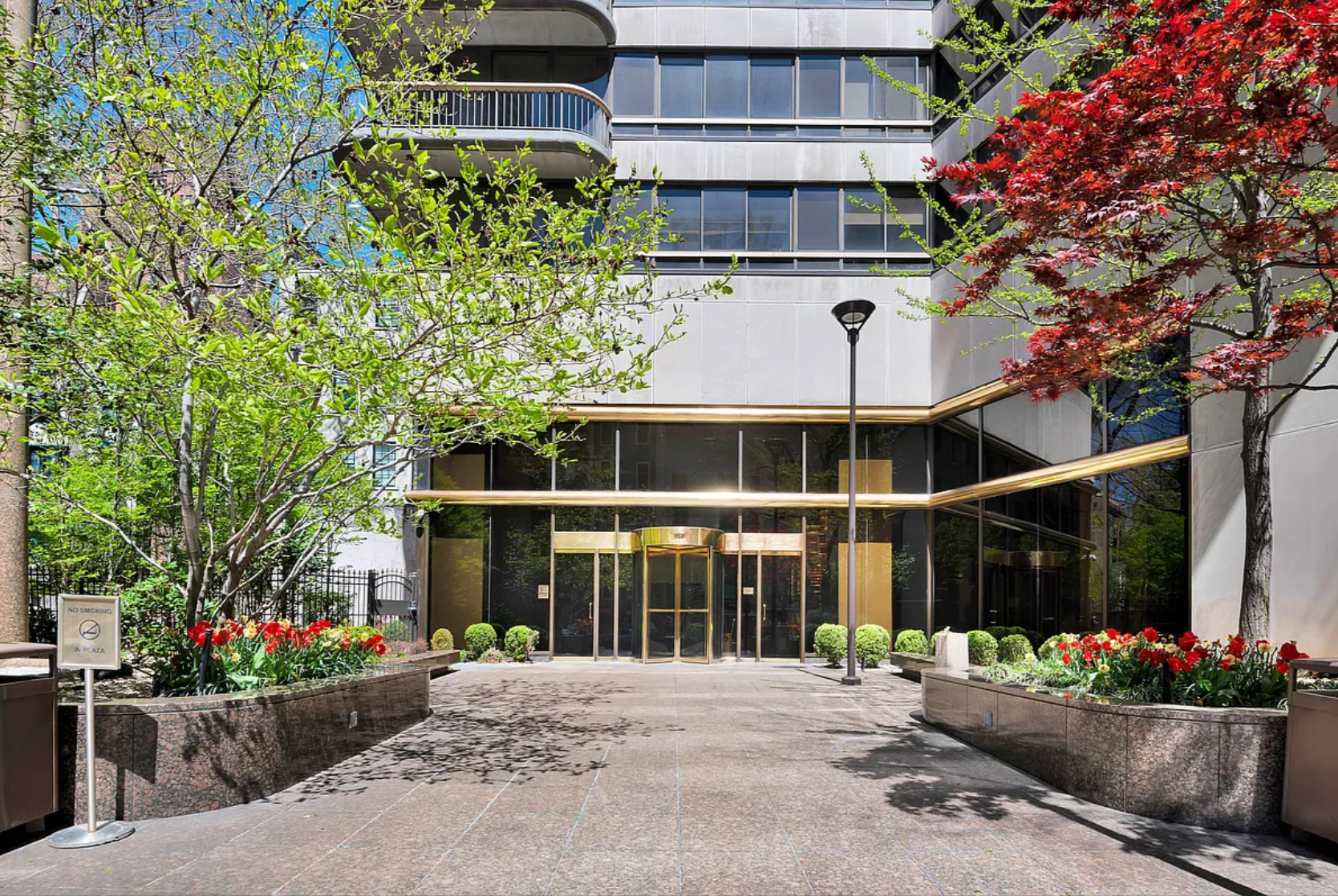 167 East 61st Street, Unit 23D Manhattan, NY 10065 - Photo 8 of 13 a front view of a house with a yard